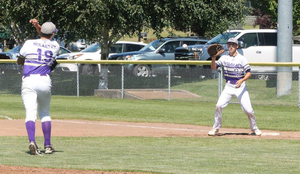Aiden McCarthy throws to first baseman Andrew Dixon for an out.(Photo by Jim Waller/Whidbey News-Times)