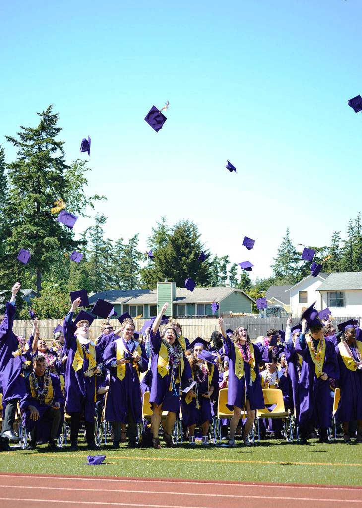 Oak Harbor High School students throw their caps into the air at the end of commencement Saturday. There were 327 graduates. Photo by Laura Guido/Whidbey News-Times