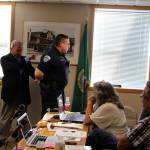 Consultant Glen Carpenter asked Langley Police Chief to help demonstrate handcuffing protocol and other arresting techniques during his 90-minute presentation of his use of force investigation into allegations against Marks. Photo by Patricia Guthrie/Whidbey News Group