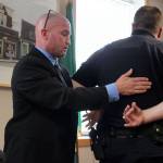 Consultant Glen Carpenter asked Langley Police Chief to help demonstrate handcuffing protocol and other arresting techniques during his 90-minute presentation of his use of force investigation into allegations against Marks. Photo by Patricia Guthrie/Whidbey News Group