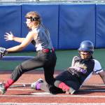 North Whidbeys Loto Tupu slides safely into home while Central Whidbeys Chloe Marzocca waits for the throw. (Photo by John Fisken)