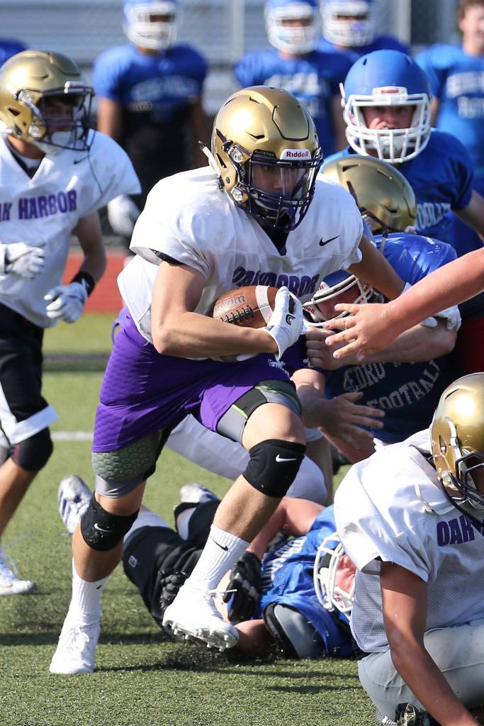 Calvin Whelpley bolts through a hole in Tuesdays scrimmage.(Photo by John Fisken)