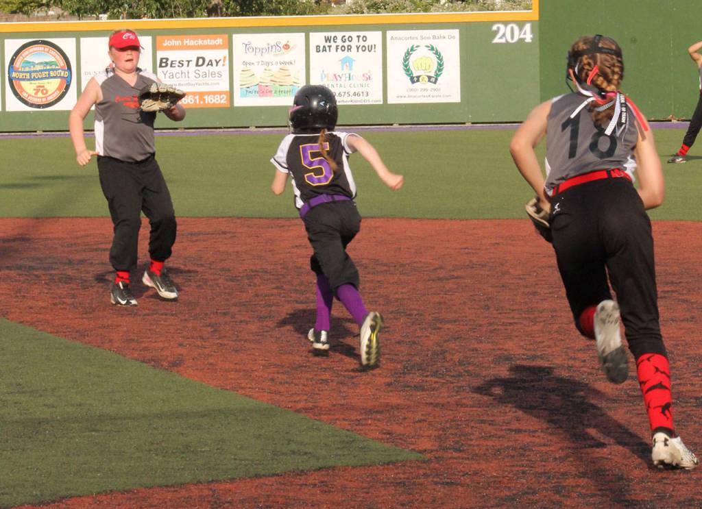 North Whidbeys Leilah Edwards (runner) and Central Whidbeys Katie Marti, left, and Mia Farris.(Submitted photo)