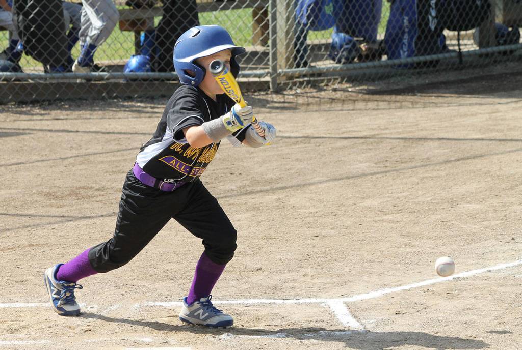 Roland Garrett puts down a bunt for a base hit against Sedro-Woolley Saturday.(Photo by Jim Waller/Whidbey News-Times)