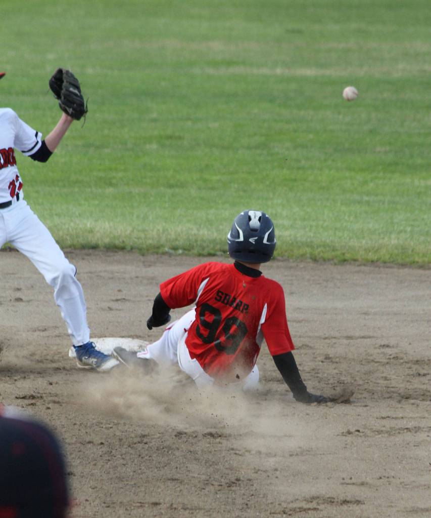 Sage Sharp steals second base as the ball sails into center field. (Photo by Jim Waller/Whidbey News-Times)