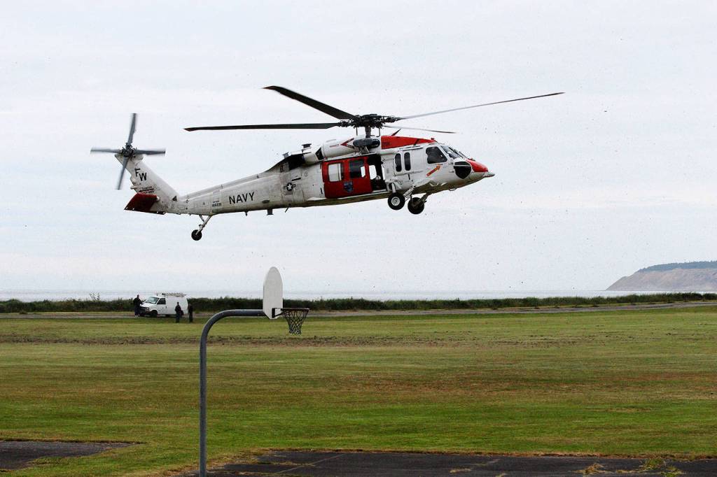 One of Naval Air Station Whidbey Island Search and Rescues helicopters, a MH-60S Knighthawk, lands Thursday morning at Camp Casey Conference Center. Sea Cadets at the camp had the opportunity to see the aircraft up close and ask questions from the crew members who attended. Photo by Laura Guido/Whidbey News-Times