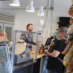 Alex Pulichino waits on costumers at the new Greenbank Pantry and Deli that sells groceries, fresh items, wine, beer and freshly-made salads and sandwiches. Hours are 8 a.m.to 6:30 p.m. every day; closed Sunday. Photo by Patricia Guthrie/Whidbey News Group