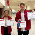 Fernandez, left, and George show off their awards.