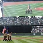The Oak Harbor High School color guard is displayed on the video screen at Safeco Field Sunday. (Photo by John Fisken)