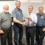 WhidbeyHealth photo                                Pictured are EMS Medical Director Dr. Paul Zaveruha, paramedic Nicholas Runions, EMS Manager Roger Meyers and Tom Cross, EMT Runions partner.