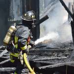 Firefighter Jeffrey Rhodes sprays inside a house on Classic Road that caught fire Wednesday. The building was already falling apart by the time fire crews arrived. It took the crew a few hours to completely put out all the flames because they couldnt enter the structurally unsound building.