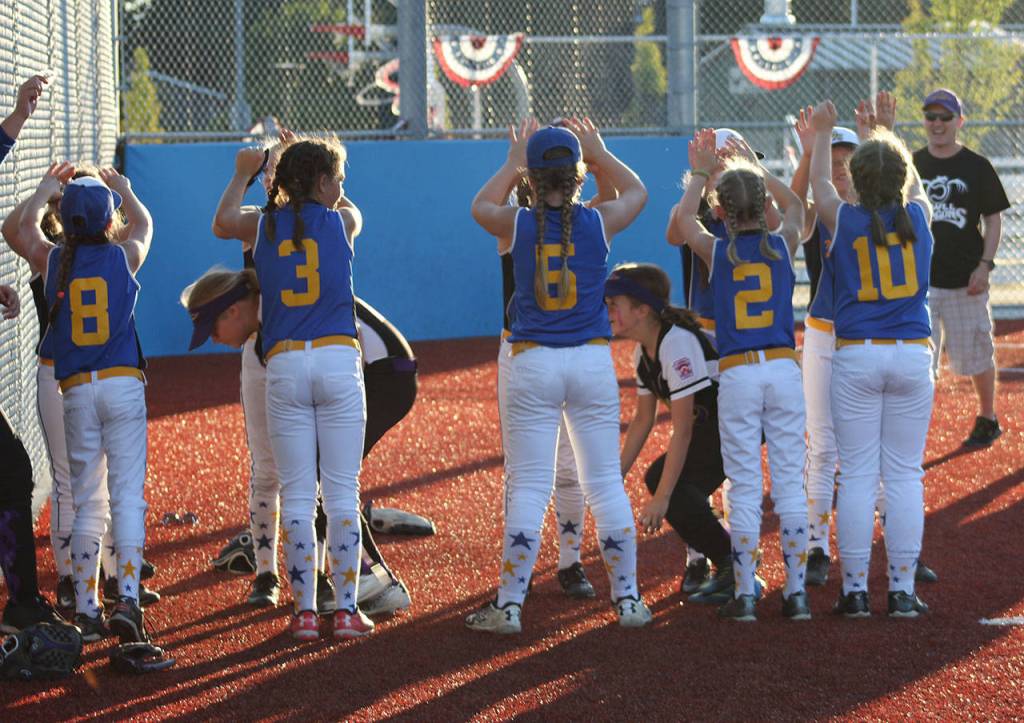 Above and below, the two teams display sportsmanship after the game.(Photo courtesy of Liz Davis)
