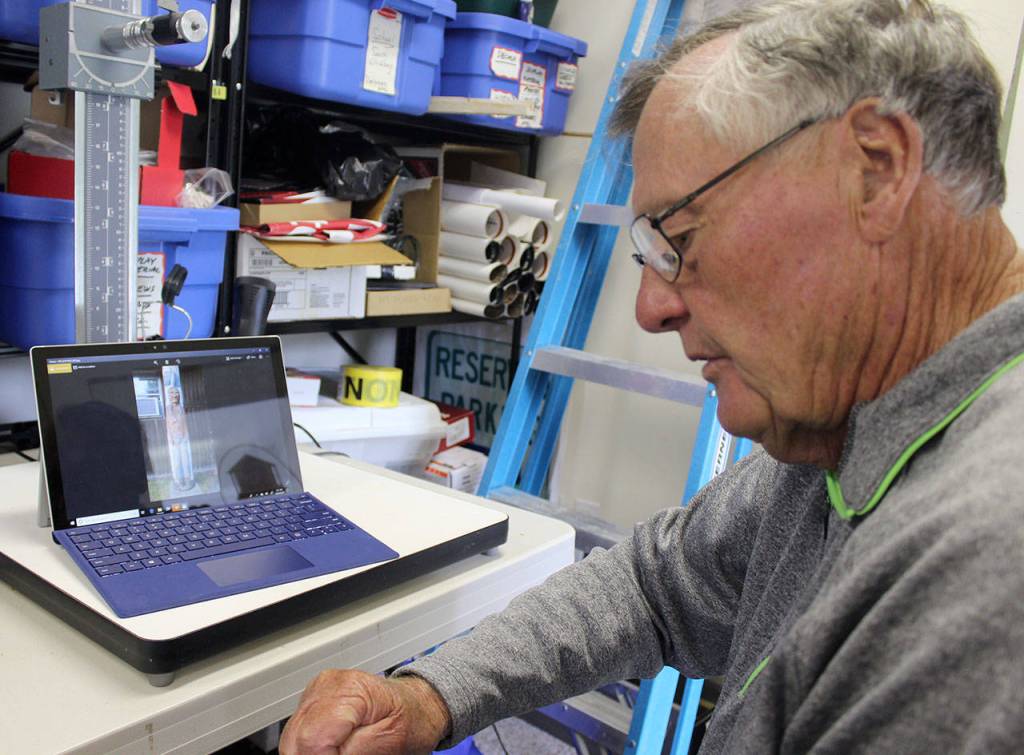 Bill Haroldson, president of the South Whidbey Historical Society, has turned detective in pursuit of the story behind the story pole. Photo by Patricia Guthrie/Whidbey News Group