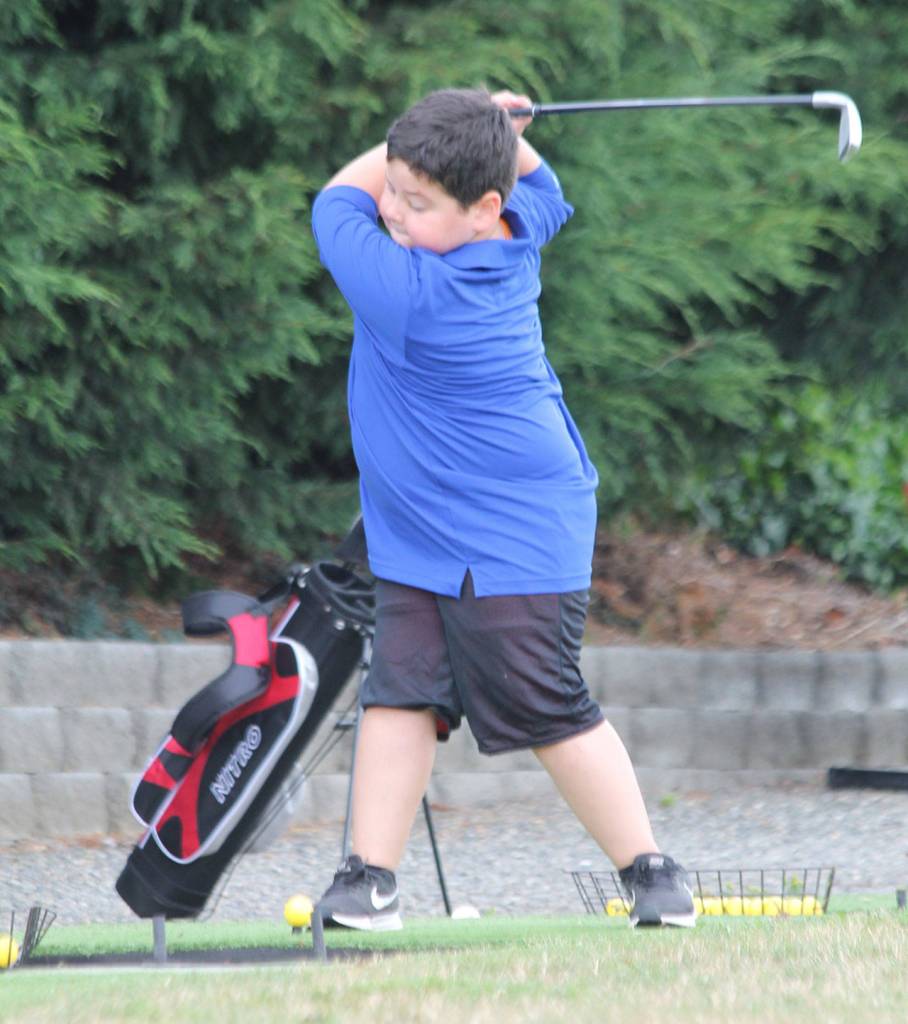 Harrison Rodgers blasts a shot on the driving range.(Photo by Jim Waller/Whidbey News-Times)
