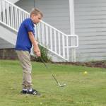 Nathan Hacket chips during Junior Golf Camp this week at the Whidbey Golf Club.(Photo by Jim Waller/Whidbey News-Times)