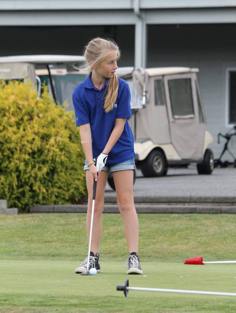 Scarlett Nations gets ready to putt Thursday at camp.(Photo by Jim Waller/Whidbey News-Times)