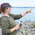 Jessica Larson, land steward at the Whidbey Camano Land Trust, points out where a 100-year-old dike was breached two years ago to create a pocket estuary. Since then, juvenile salmon and many species of birds have been documented utilizing the newly created habitat. Photo by Laura Guido/Whidbey News-Times