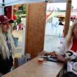 Bartender Courtney Fredriksen talks to Deborah Abbott about the beer and coffee combo served during the Whidbey Island Fair. Pyramid Brewing and Whidbey Coffee recently joined forces to create Whidbey Coffee Pale Ale.                                Abbott said she liked the flavor and ordered a glass after having a small taste. Its like an energy beer, she declared. I feel energized from that little sip. Photo by Patricia Guthrie/Whidbey News Group