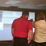 An Oak Harbor Police Department Citizens Advisory Board member uses a firearms training simulator. Participants of the free Citizens Academy held by the Oak Harbor Police Department will likely have the chance to use the simulator and do other police training during the program. Photo provided