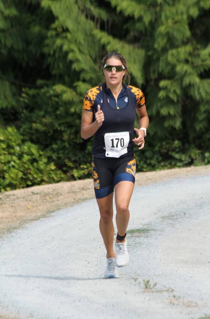 Heather Ireland, who is stationed at Naval Air Station Whidbey Island, runs to first place among women at Saturdays triathlon.(Photo by Jim Waller/Whidbey News-Times)