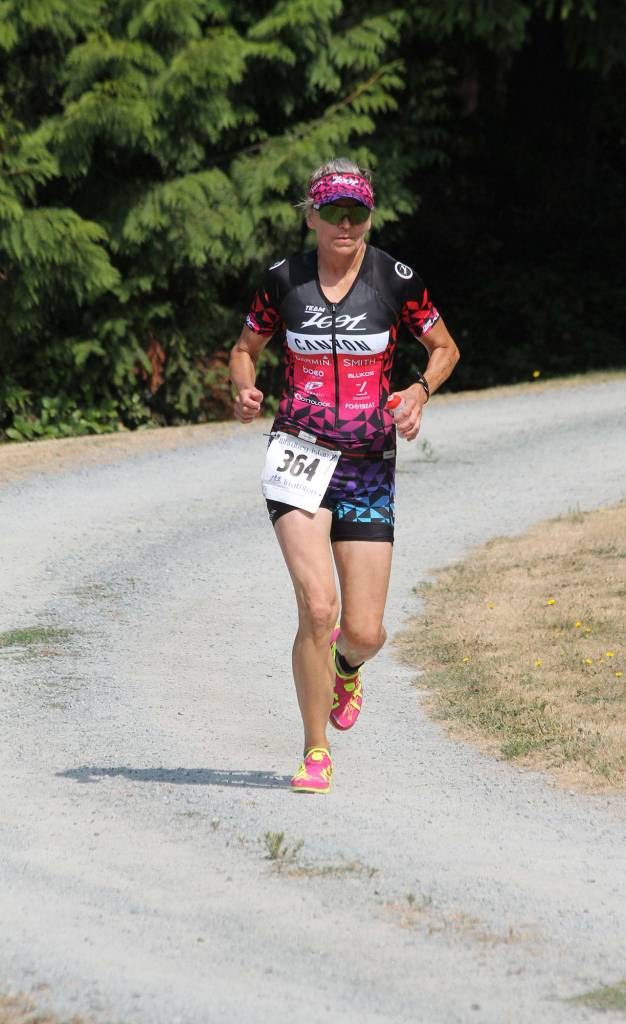 Coupevilles Christina Bromme runs through the trails of Langleys Community Park. (Photo by Jim Waller/Whidbey News-Times)
