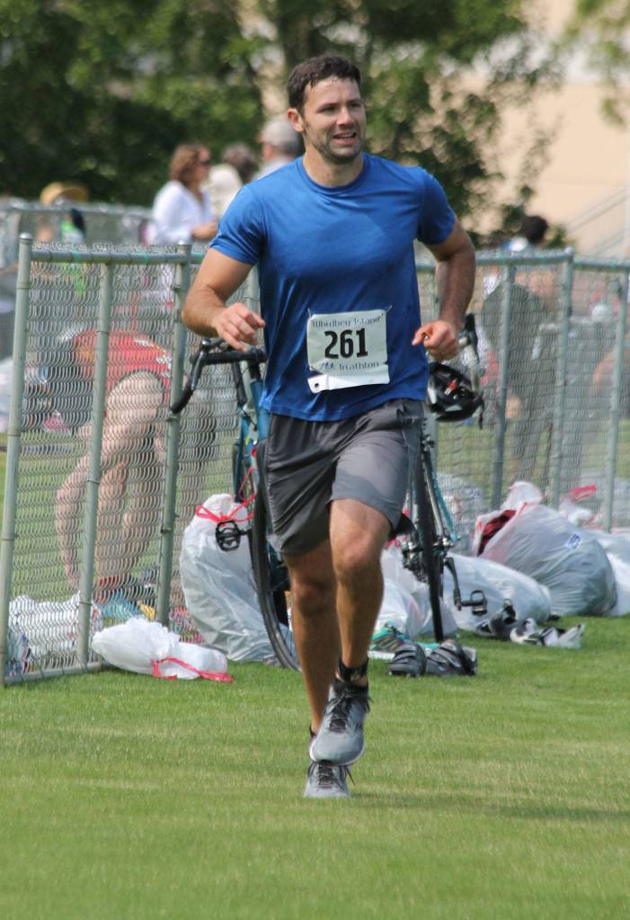 Oak Harbors Tim Nigro begins the final 3.8-mile running leg after dropping off his bike. (Photo by Jim Waller/Whidbey News-Times)