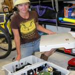 Photo by Dave Felice / Whidbey News-Times.                                Whidbey electrician Golda Moore prepares the inverter for a new solar energy installation in Cedar Cove.