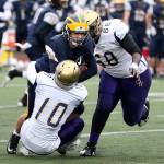 Left: In last years state playoffs, Mac Carr brings down a Bellevue ball carrier as DeAndre Bennett closes in. The WIAA will use committees to seed the teams in this years state tournament. (Photo by John Fisken)