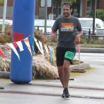 Coupevilles James Steller crosses the finish line of the half marathon during the running of the Race the Reserve Saturday. (Photo by Jim Waller/Whidbey News-Times)