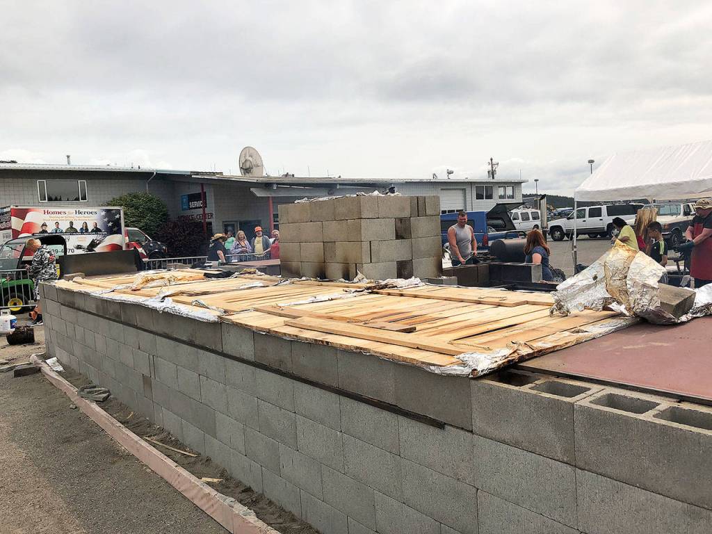 The potentially Guinness record-setting smoke pit designed by John Ryan was a constant feature of Pigfest on last Sunday. Leader Scott Fraser said the bid has been submitted for the 1,000 cinder block smoke pit. Photo by Emily Gilbert/Whidbey News-Times