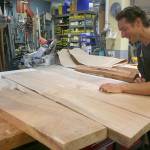 Photo by Emily Gilbert / Whidbey News-Times                                Glen Pearson inspects the Maple wood slabs that will become the top of the table hes making for Woodpalooza this year. He said itll take him about 60 hours to have the table finished.
