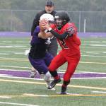 Coupeville quarterback Dawson Houston escapes an Anacortes defender in Saturdays jamboree. (Photo by Jim Waller/Whidbey News-Times)