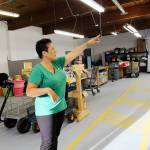 Garage of Blessings foundation Kristiina Miller points shelves built by volunteers to help the organization move into its new location. The nonprofit opened the doors to the old Whidbey News-Times building on Barrington Drive on Sept. 4. Photo by Laura Guido/Whidbey News-Times