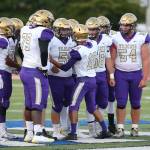 Quarterback Caleb Fitzgerald and the Oak Harbor offense meets in the huddle during Fridays win against Seaquam. (Photo by John Fisken)