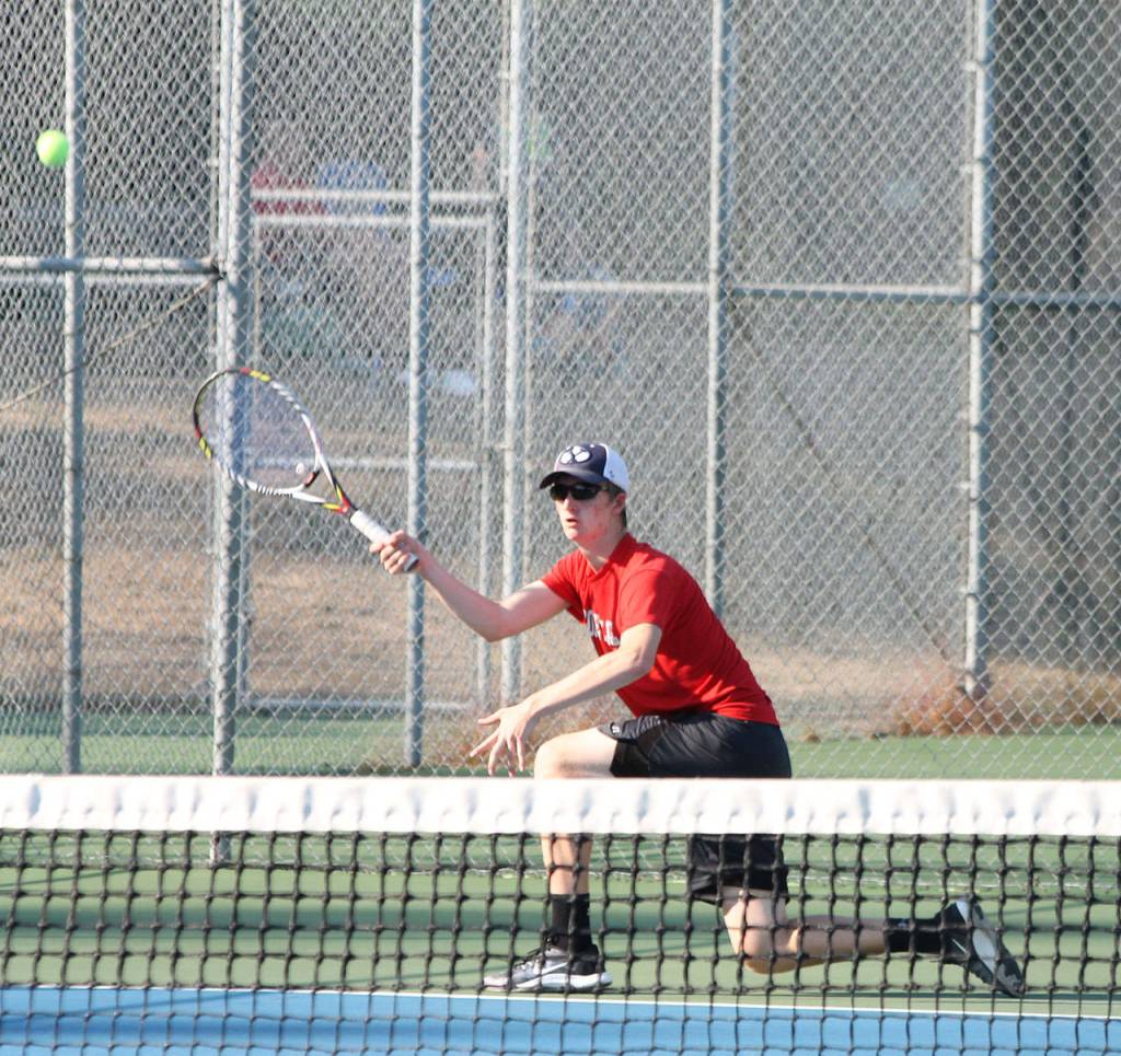 Jakobi Baumann returns a shot while winning the first singles match.(Photo by Jim Waller/Whidbey News-Times)