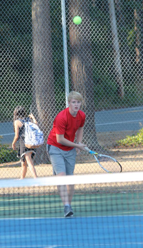 Jaschon Baumann follows the flight of his serve.(Photo by Jim Waller/Whidbey News-Times)