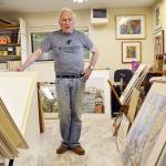 Charley Ryder stands in his basement, which is full of over 50 years of paintings done by his late wife Helen Ryder. Helen Ryder, a member of Whidbey Allied Artists, died in March and her art will be featured by WAA starting Sept. 21 at the Coupeville Recreation Hall. Photo by Laura Guido/Whidbey News-Times