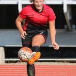 Genna Wright communicates while advancing the ball for the Wolves. (Photo by John Fisken)