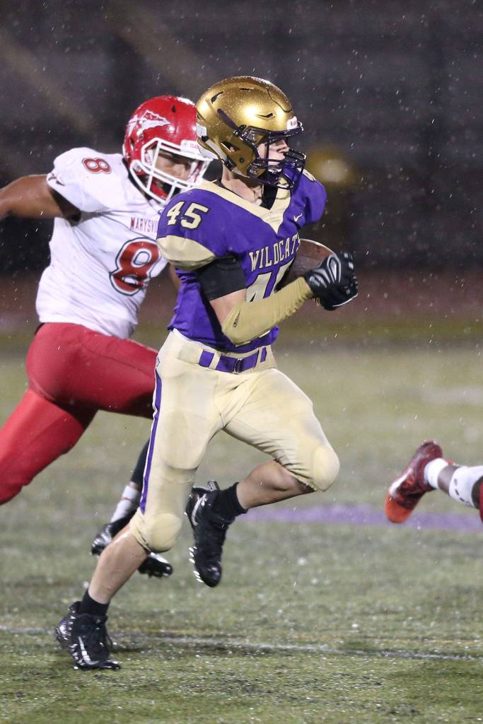 Caden Leckelt picks up some yardage for the Wildcats.(Photo by John Fisken)