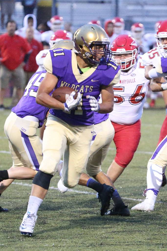 Aaron Martinez looks for some running room Friday.(Photo by John Fisken)