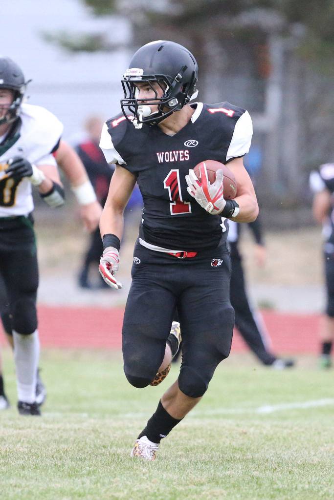Sean Toomey-Stout picks up big yardage for the Wolves.(Photo by John Fisken)