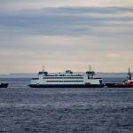 The Salish is towed by a tug boat back to Port Townsend after making a soft grounding in Keystone Harbor. The vessels rudder was damaged and the Coupeville-to-Port Townsend run will be down to one boat until it can be fixed. Photo by David Stern - Whidbey Custom Photography