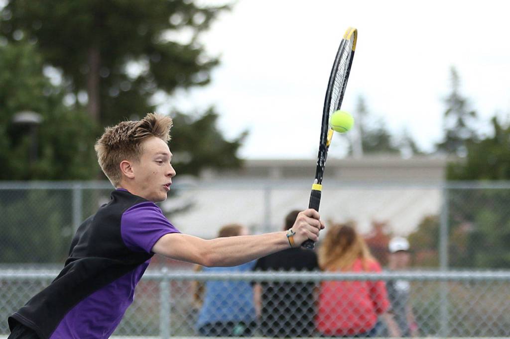 Nathan Merrill uses an overhand shot to return a volley.(Photo by John Fisken)