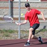First-singles player Jakobi Baumann returns a shot Tuesday.(Photo by John Fisken)