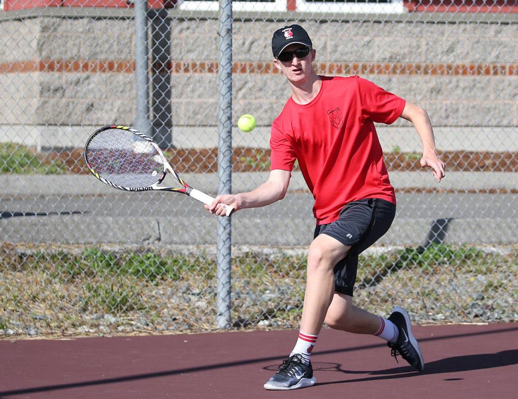 First-singles player Jakobi Baumann returns a shot Tuesday.(Photo by John Fisken)