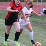 Maddy Hilkey, left, races a Kings player to the ball.(Photo by John Fisken)