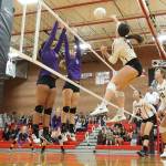 Ashely Menges drives the ball by an Anacortes double block.(Photo by John Fisken)
