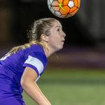 Peyton Rhyne advances the ball with a header for Oak Harbor.(Photo by John Fisken)