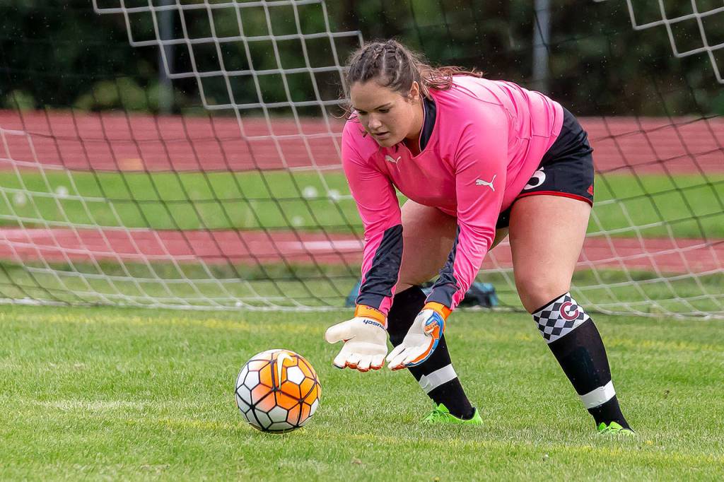 Sarah Wright scoops up the ball for Coupeville.(Photo by John Fisken)