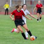 Mary Milnes punches the ball forward for the Wolves.(Photo by John Fisken)